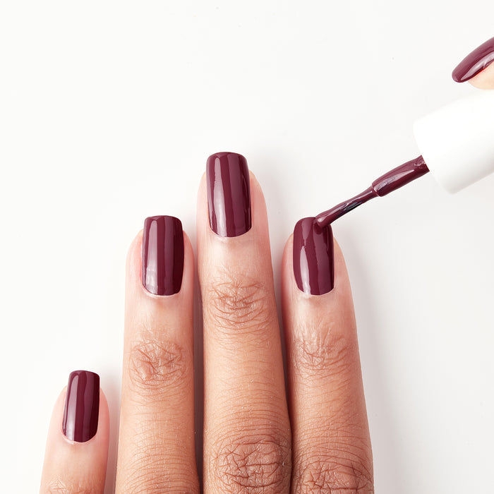 Applying La Vie en Rose dark berry nail polish