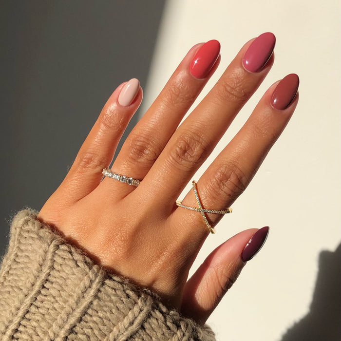 La Vie en Rose berry and blush mix-and-match manicure with rings in sunlight