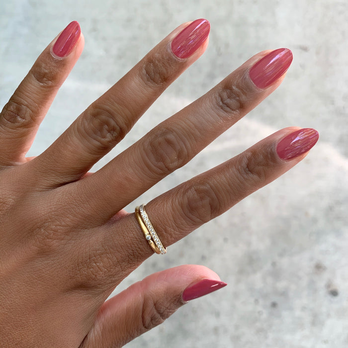 Hand with nails painted in Olive and June LD rosy pinky rosewood shade for a sleek and elegant manicure look