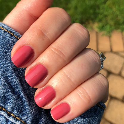 Hand with nails painted in LD rosy pinky rosewood shade for a polished and versatile at-home manicure look