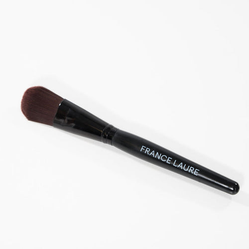France Laure makeup brush with black handle and dense brown bristles, ideal for flawless cosmetic application on all skin types.