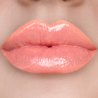 No More Games peach coral lip gloss on lips, light skin tone