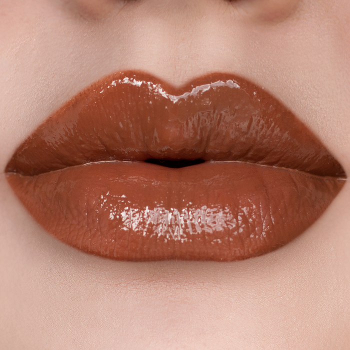 Oh Deer caramel brown lip gloss on lips, light skin tone