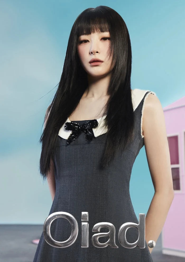 Woman wearing a black dress with a bow detail against a light blue background, featuring the brand 'Oiad'.