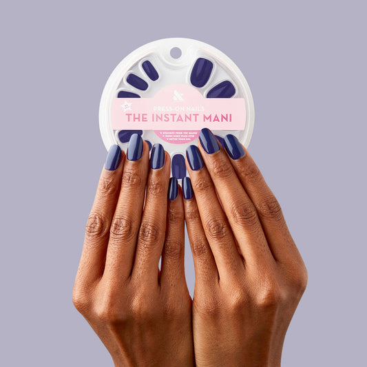 OMG - Press-On | Short | Round showing hands with deep indigo short round press-on nails holding circular nail kit