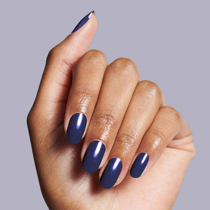 Hand showing smooth, glossy manicure with deep indigo OMG nail polish for a long-lasting, salon-quality mani by Olive and June