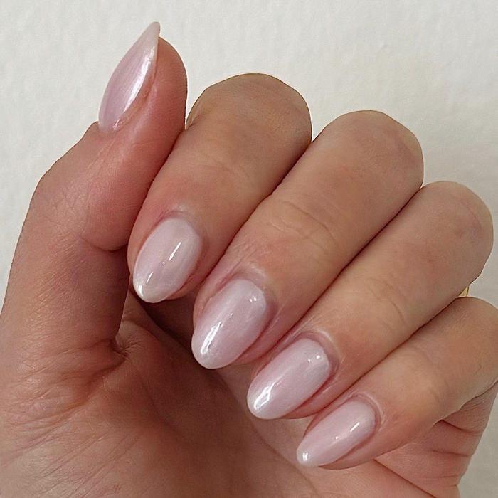 Pearl Polish Set featuring soft neutral pink nails with a subtle pearlescent shimmer for a smooth manicure look