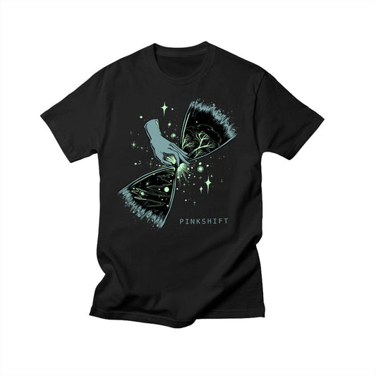 Exclusive Pinkshift design on a black Comfort Colors T-shirt shows an illustrated hand tearing open a starry sky to reveal branches and leaves. PINKSHIFT is printed beneath the artwork.