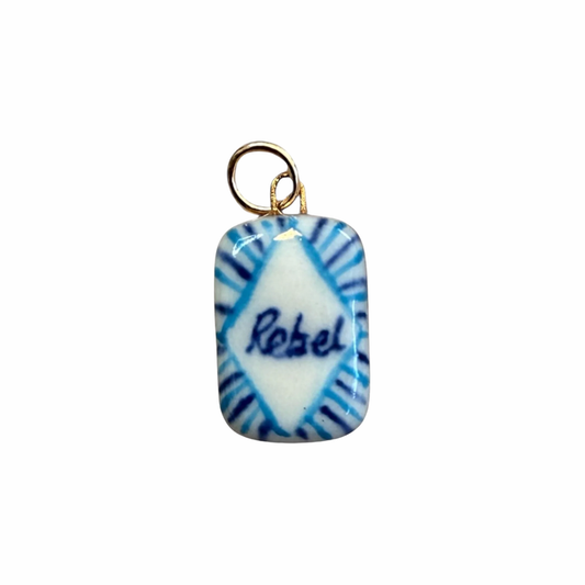 Porcelain charm pendant with blue swirl design and 'Rebel' text, gold loop