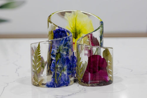 Landscape photo of a pressed flower makeup brush holder on a bathroom counter
