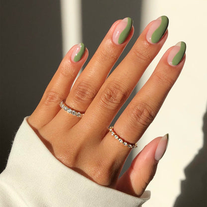 Pure sheer peach nail polish with sage green French tip nail art and rings