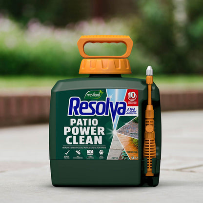 Resolva Patio Power Clean product with a brush attachment on a blurred outdoor background