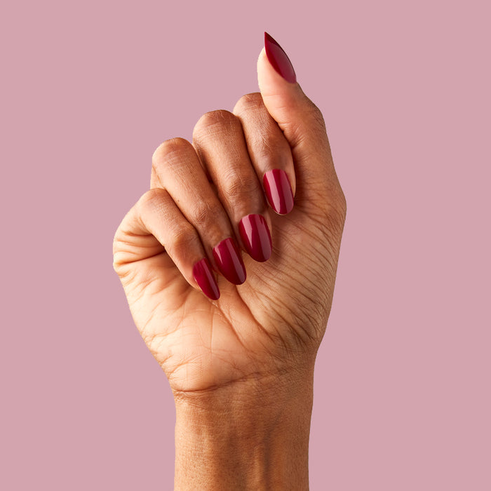 SC - Press-On | Medium | Oval hand with medium oval false nails in deep bordeaux polish for sophisticated at home mani