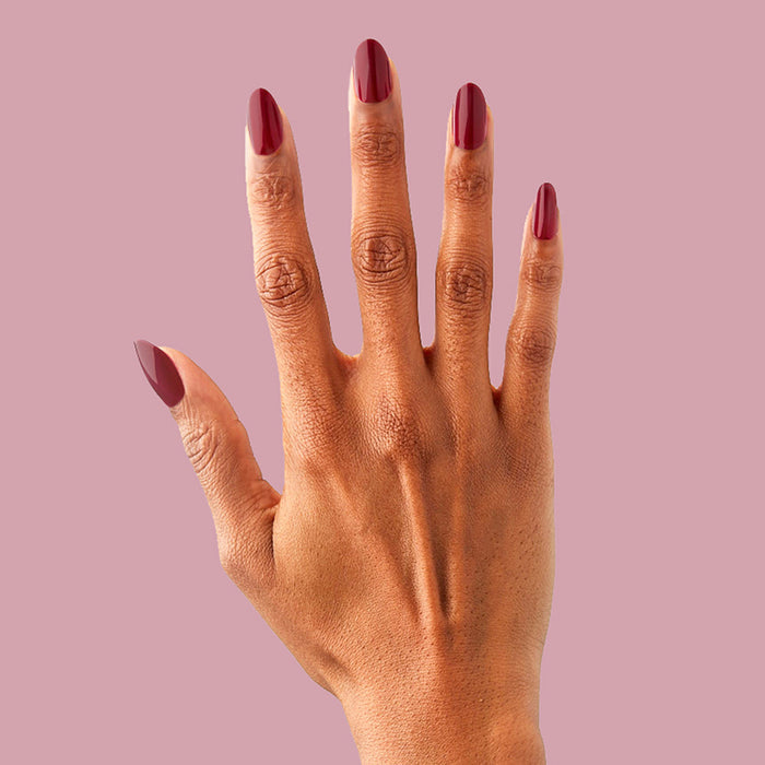 SC - Press-On | Medium | Oval hand with medium oval false nails in deep bordeaux polish for elegant at home manicure