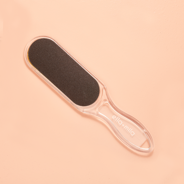 Dual-sided foot file on a peach background