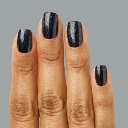 Hand showing nails painted in SPACEY black shimmer polish with a glossy, long-lasting mani finish