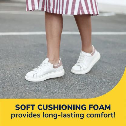 White sneakers with cushioned insoles under the feet on pavement