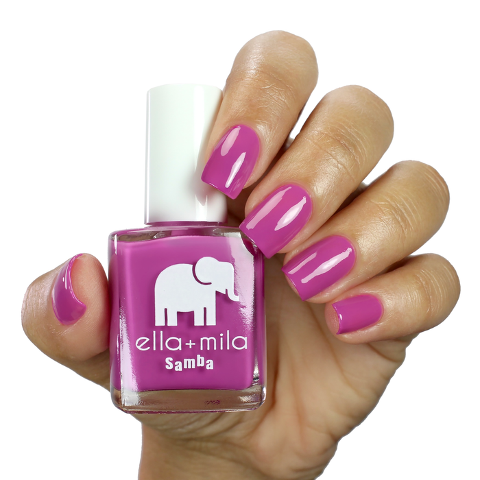 Staycation Vacation fuchsia purple nail polish manicure on a light skin tone with the bottle