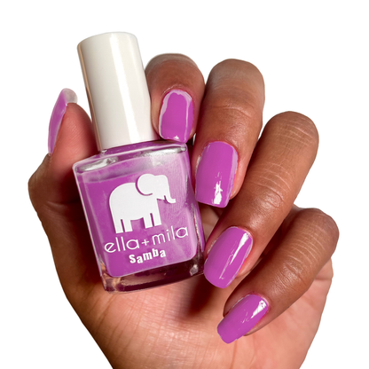 Staycation Vacation fuchsia nail polish on a deep skin tone, hand holding the bottle
