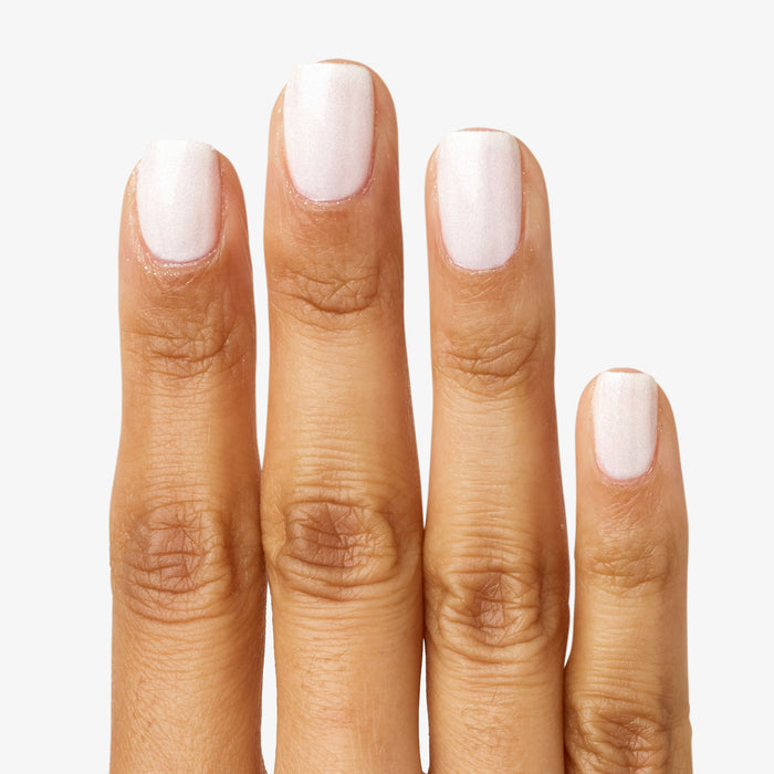 Fingernails coated in STELLAR sparkly white polish for a smooth, long-lasting mani with subtle shimmer effect