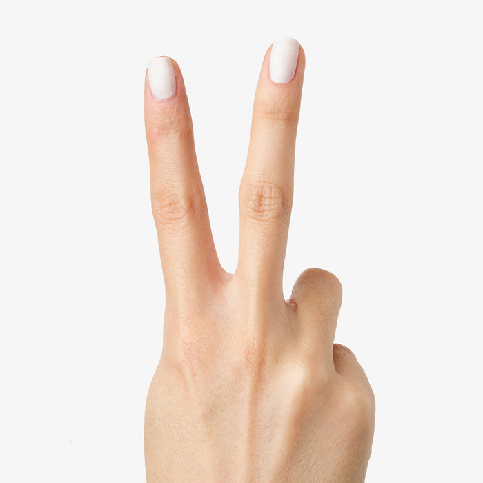 Hand showing a peace sign with nails painted in STELLAR polish for a smooth, sparkly long-lasting manicure finish