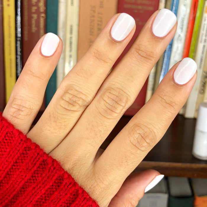 Hand with nails painted in STELLAR polish showing a smooth, long-lasting manicure with subtle sparkly white shimmer finish