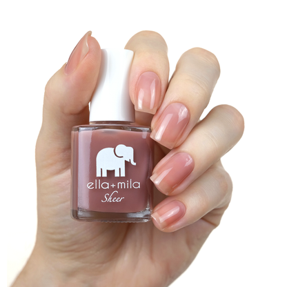 Strong sheer brown mauve tint nail polish manicure on a light skin tone with the bottle