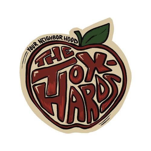 A stylized, scented illustration of an apple with a green leaf, featuring the words THE TOXHARDS in bold, playful lettering.