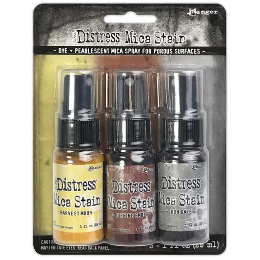 Tim Holtz - Distress Mica Stain Set - Halloween Set# 3. Tim Holtz Distress Halloween Mica Stains add colorful pearlescent shimmer to mixed media and paper craft projects. Mica Stains adhere to paper, canvas, wood, fabric and other porous surfaces. Available at Embellish Away located in Bowmanville Ontario Canada.