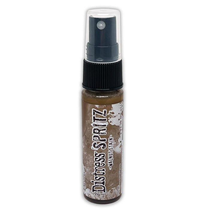 Tim Holtz = Distress Spritz 1oz Bottle - Select from Drop Down. Uncharted Mariner, Picked Raspberry, Spiced Marmalade, Fossilized Amber, Peeled Paint, Twisted Citron, Worn Lipstick, Walnut Stain, Wilted Violet, Barn Door, Weathered Wood, Peacock Feathers Available at Embellish Away located in Bowmanville Ontario Canada Walnut Stain
