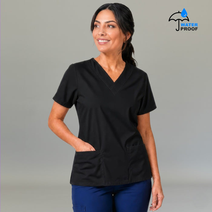 Women's black 502 scrub top with hand in front pocket — lightweight fluid-resistant nursing top S-FOR-ME