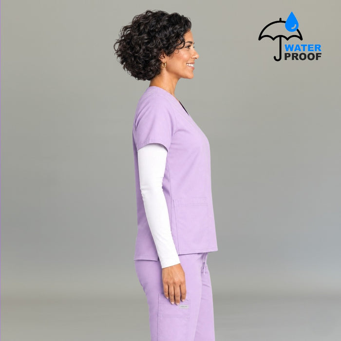 Side profile view of women's lilac 502 scrub top layered over white underscrub — lightweight fluid-resistant medical uniform S-FOR-ME