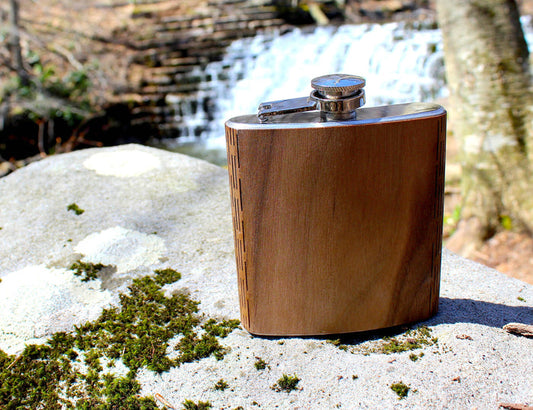 Handcrafted black walnut wooden hip flask from WUDN, featuring a smooth finish and compact design for portable use.