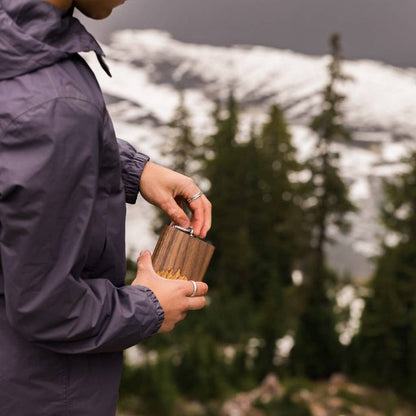 Black walnut wooden hip flask from WUDN Handcrafted, showcasing smooth polished wood and sleek design.