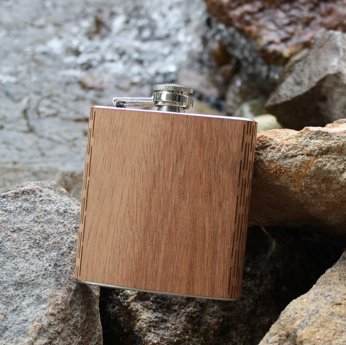 Black walnut wooden hip flask by WUDN Handcrafted, showcasing smooth polished wood and a sleek, curved design.