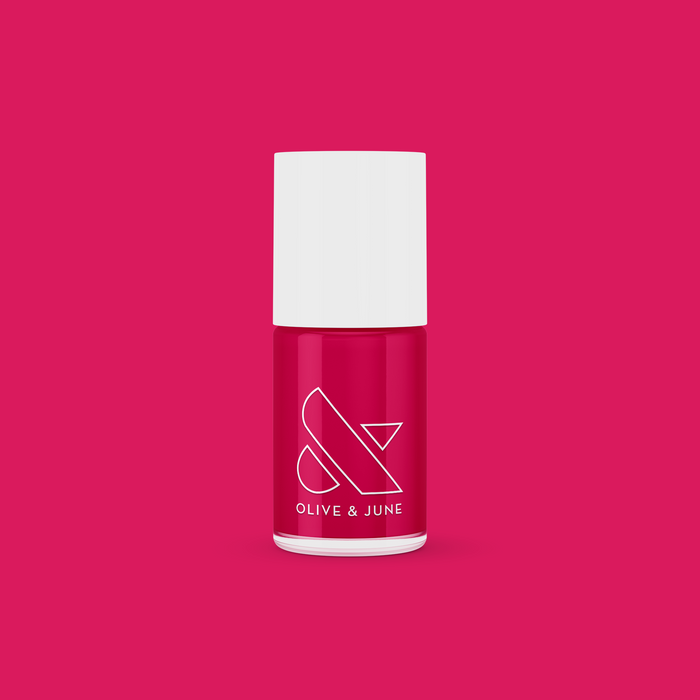 XOXO nail polish bottle in bright hot pink shade on matching pink background for vibrant manicure looks