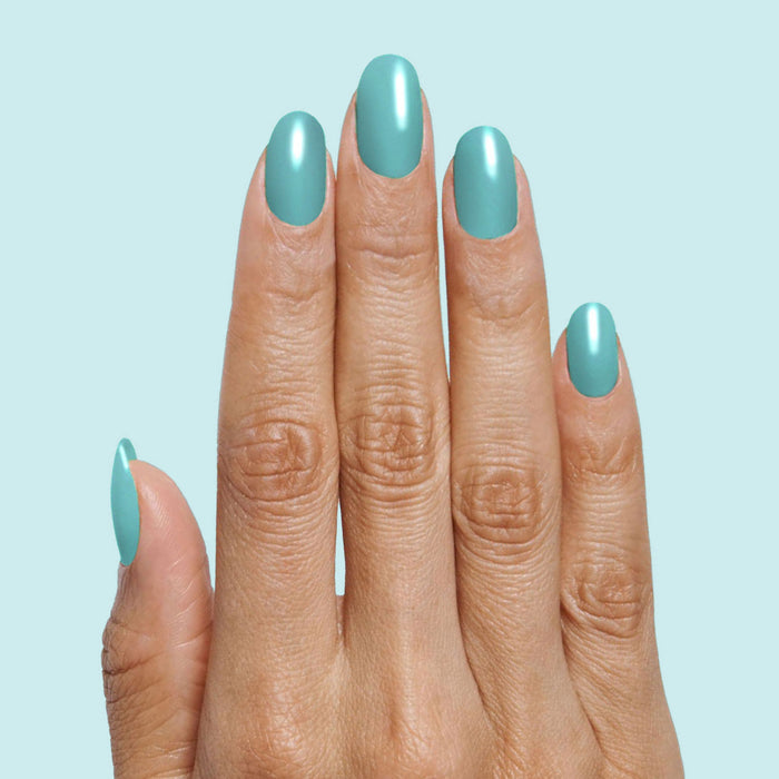 Hand with nails painted in smooth turquoise shade Yes Please for a durable, vibrant manicure by Olive and June